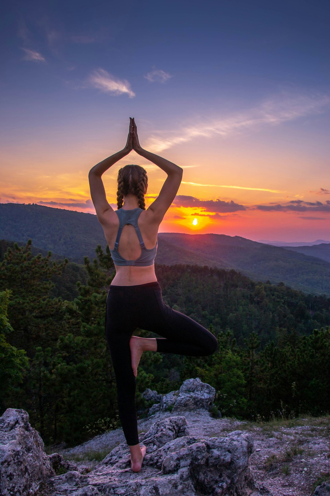 services-05 woman-in-black-leggings-standing-on-rock-formation-during-sunset-cxnglqf7xdo